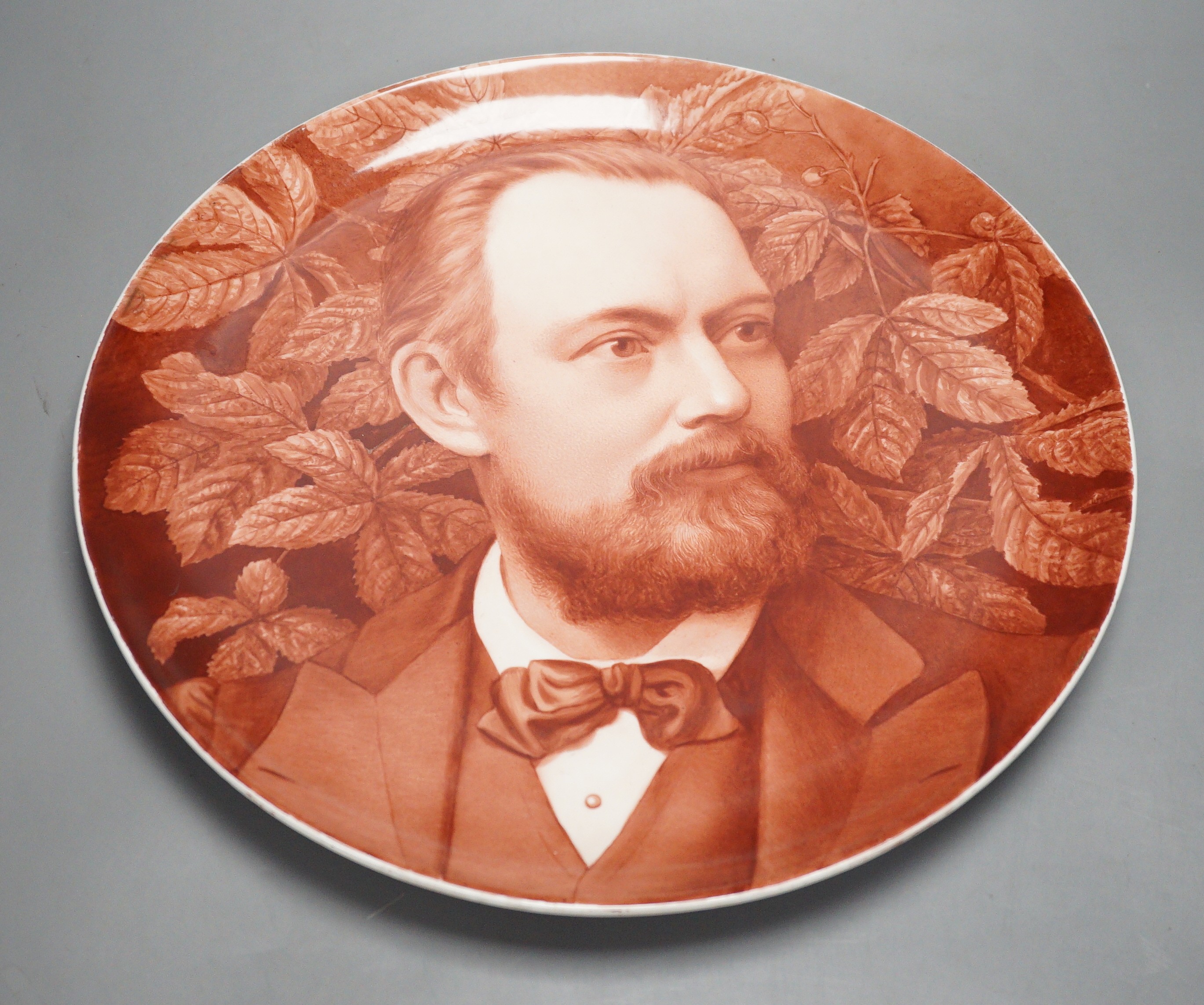 A late 19th century art pottery handpainted portrait dish, 36cm diameter